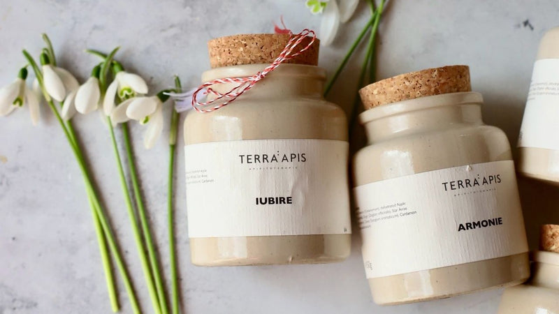 Borcane de miere raw Apiarium Iubire, Armonie și Îmbrățișare, alături de ghiocei și șnur de mărțișor, simbolizând sănătatea și renașterea primăverii.