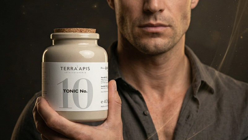 Man in a dark shirt presenting a beige bottle labeled Terra Apis Tonic No. 10 toward the camera.